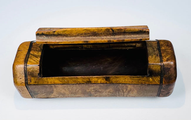 English pocket snuff box with richly figured burr wood, ebony-style stringing, and elongated single compartment.