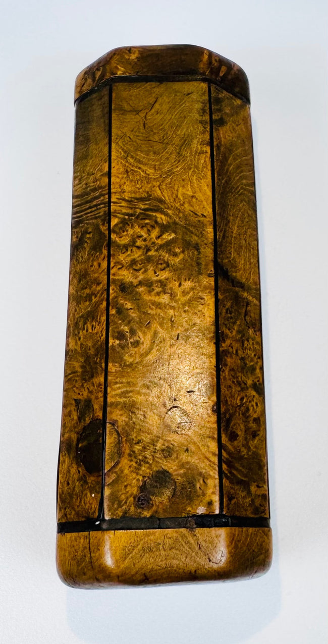 Antique treen snuff box in burr walnut with octagonal cross-section, dark banding, and aged polished surface.