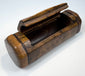 Antique rectangular burr walnut snuff box with faceted sides, rounded ends, and contrasting dark wood inlay.