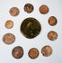 Ten Late Roman bronze coins arranged around a large central imperial coin, showing varied flan sizes, wear, and historic patination.