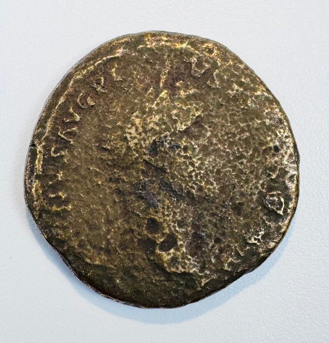 Large ancient Roman bronze coin with worn right-facing imperial portrait, partial Latin inscription, and dark olive-brown patina.