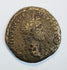 Large ancient Roman bronze coin with worn right-facing imperial portrait, partial Latin inscription, and dark olive-brown patina.