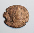 Ancient Late Roman bronze coin with right-facing emperor portrait, irregular flan, partial legend, and reddish-brown patina.