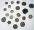 Ancient bronze coin collection showing heavily patinated surfaces, irregular edges, and surviving traces of imperial and reverse designs.