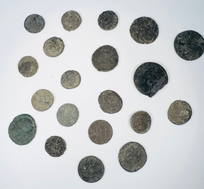 Mixed group of Roman Imperial and possible early Byzantine copper-alloy coins with worn portraits, inscriptions, and mineral encrustation.