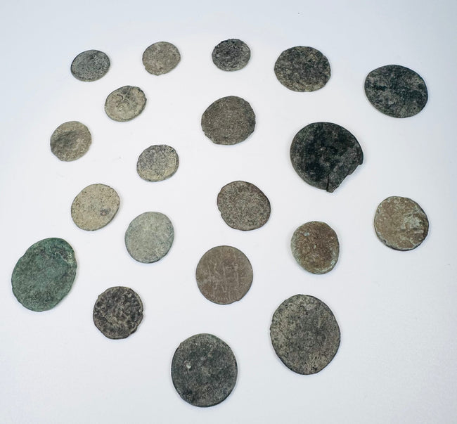 Twenty ancient Roman and Late Antique coins ranging from small bronze denominations to larger copper-alloy issues with historic corrosion and wear.