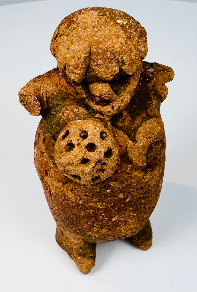 Side view of Late Classic Maya ceramic figure rattle with sculptural headdress and aged patina