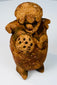 Side view of Late Classic Maya ceramic figure rattle with sculptural headdress and aged patina