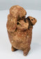 Pre-Columbian Maya terracotta rattle figure showing perforated object held across the abdomen