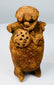 Rear view of Pre-Columbian Maya terracotta figural rattle showing headdress and firing aperture