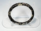 Close view of Roman glass bangle with pitting, exfoliation, and iridescent archaeological surface