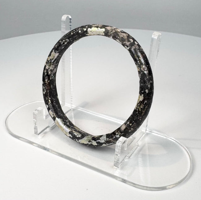 Ancient Roman burial glass bangle with naturally flaked surface revealing darker glass beneath