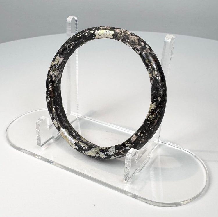 Ancient Roman burial glass bangle with naturally flaked surface revealing darker glass beneath