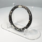 Ancient Roman burial glass bangle with naturally flaked surface revealing darker glass beneath