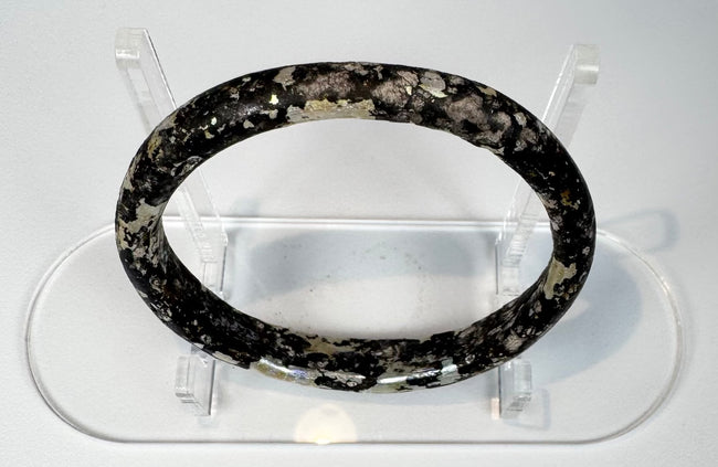 Ancient Roman glass bracelet showing dark cobalt or near-black glass beneath surface weathering
