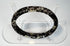Ancient Roman glass bracelet showing dark cobalt or near-black glass beneath surface weathering