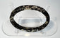 Ancient Roman glass bracelet showing dark cobalt or near-black glass beneath surface weathering