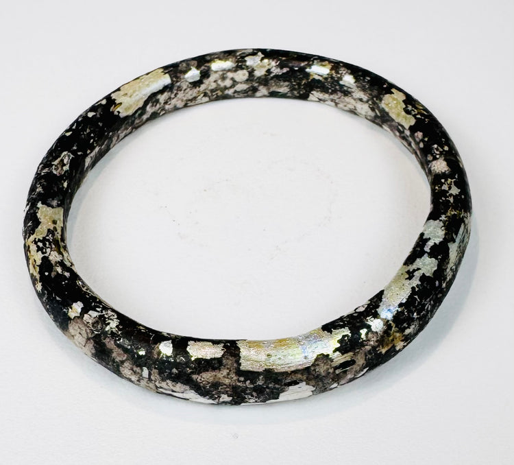 Archaeological Roman glass bracelet with heavy mineralization and rainbow-like iridescence