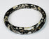 Ancient Roman dark glass bracelet with age-related pitting, dulling, and burial encrustation