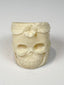 Carved camel bone jewelry ring with skull face, flower motif, and natural bone texture