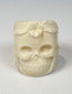 Memento mori-inspired camel bone ring with sculptural skull and foliate decoration