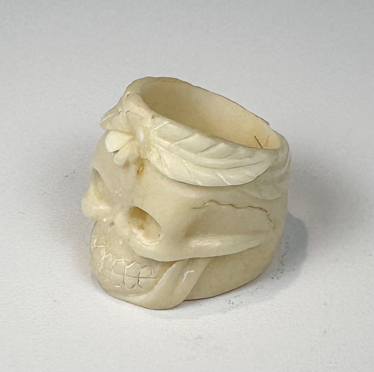 Camel bone memento mori ring with skull, floral detail, and thick carved band