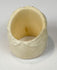 Hand-finished camel bone skull ring with pale cream coloration and carved floral details