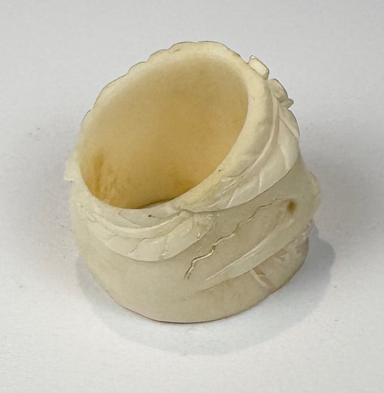 Hand-carved bone skull ring with five-petalled flower above the forehead