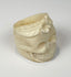 Antique-style camel bone ring carved as a human skull with flower motif
