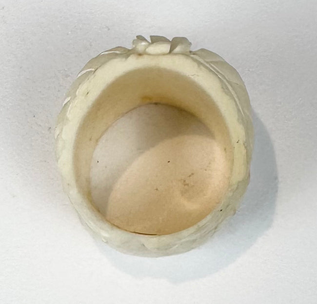Detailed camel bone skull ring with carved leaves, flower, cheekbones, and teeth