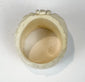 Detailed camel bone skull ring with carved leaves, flower, cheekbones, and teeth