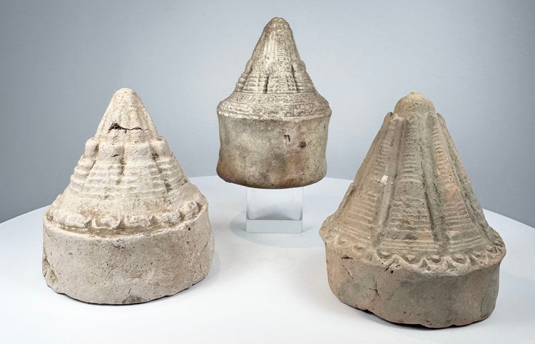 Eastern Indian clay votive stupas with ribbed spires and layered architectural ornament