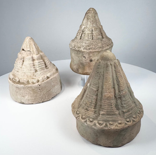 Ancient Buddhist devotional stupas with cylindrical bases and detailed moulded superstructures