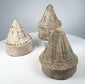 Ancient Buddhist devotional stupas with cylindrical bases and detailed moulded superstructures