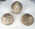 Collection of miniature Buddhist reliquary stupas in grey, buff, and cream-toned terracotta