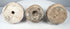 Bottom view of three Eastern Indian Buddhist terracotta votive stupas showing base cavities and impressed features