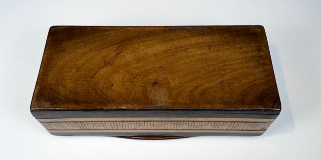 Underside of Anglo-Indian marquetry box showing natural wood base and antique construction
