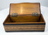 Open Anglo-Indian marquetry box showing natural wood interior and brass hinges