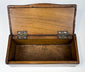 Interior view of Anglo-Indian trinket box with unlined wood compartment and brass hinges