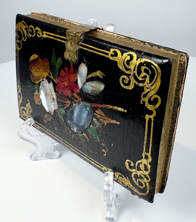 Antique papier-mâché card case with polychrome flowers, shell inlay, and ornate gold scroll decoration