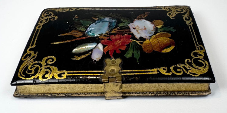 Victorian papier-mâché calling card case highlighting brass clasp, gilt ornament, and lacquered construction