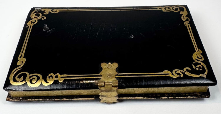 Reverse of Victorian black lacquer calling card case with gilt scrollwork border and brass clasp