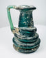 Late Roman blown-glass jug displaying blue-green translucency and naturally developed iridescence
