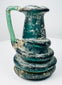 Ancient Roman blown-glass jug with folded rim and decorative raised glass trails