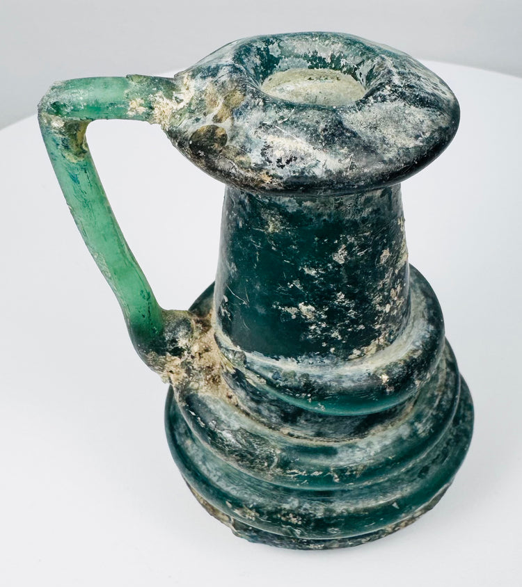 Late Roman glass vessel with thick raised trail decoration encircling the lower body