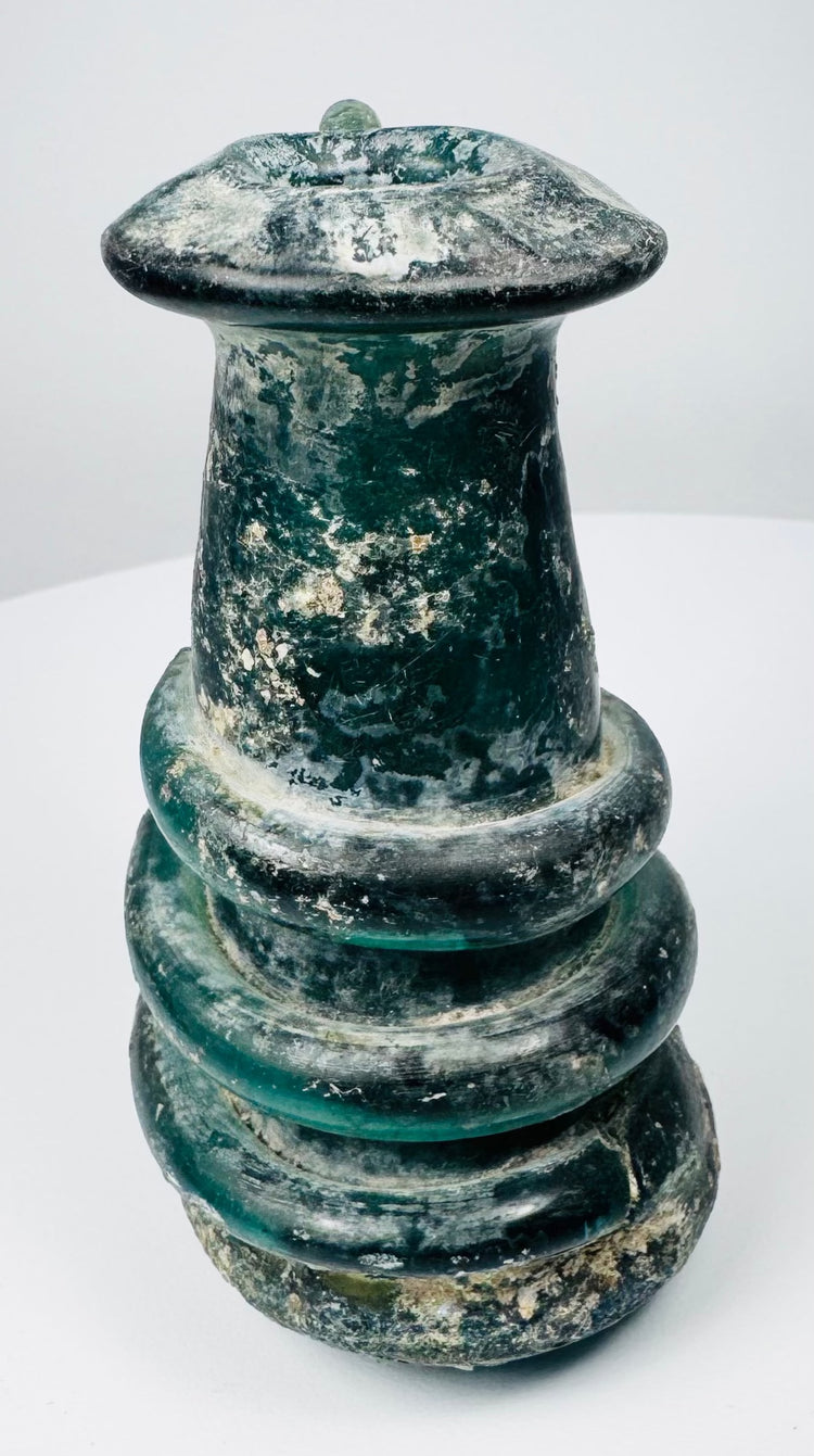 Ancient Roman blue-green glass vessel with applied trail ornament and pronounced archaeological patina