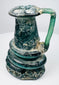 Late Roman glass jug highlighting iridescent weathering, mineral accretions, and hand-blown construction