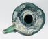 Top view of Late Roman glass jug showing circular mouth, flared rim, applied handle, and blue-green glass