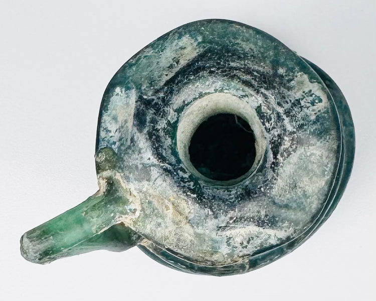 Top view of Late Roman glass jug showing circular mouth, flared rim, applied handle, and blue-green glass