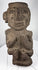 Ancient Mezcala-style stone effigy with geometric head, elongated nose, and compact seated form